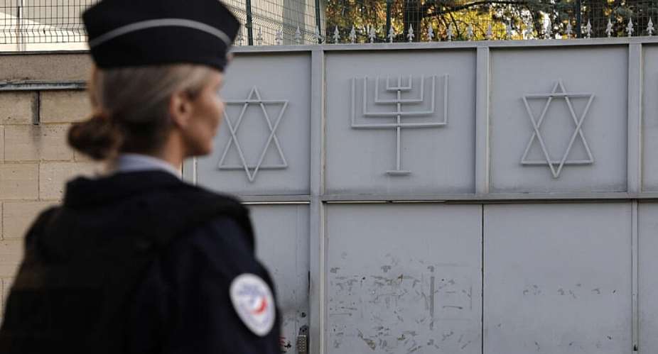 A French police officer stands guard in front of the Synagogue of Sarcelles, Pariss suburb, on October 11, 2023. -  Geoffroy Van Der Hasselt, AFP