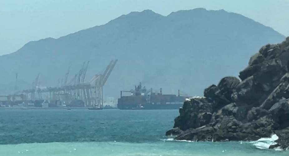 Image from an AFPTV video dated July 12, 2026, showing a ship near the Strait of Hormuz, off the eastern coast of the United Arab Emirates, at Khor Fakkan -  AFP