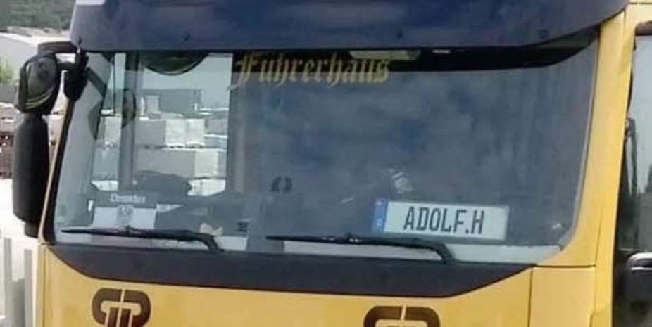 A Truck on the highway with extremely questionable logo ADOLF .H