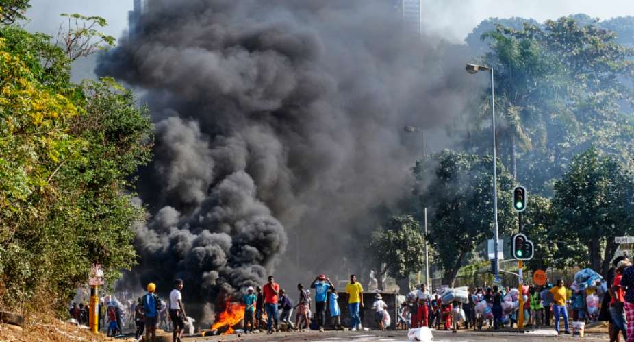 Demonstrators are seen outside a shopping center in Durban, South Africa, on July 12, 2021. Protesters and looters recently attacked four radio stations in the country and harassed, attacked, and threatened journalists. APAndre Swart