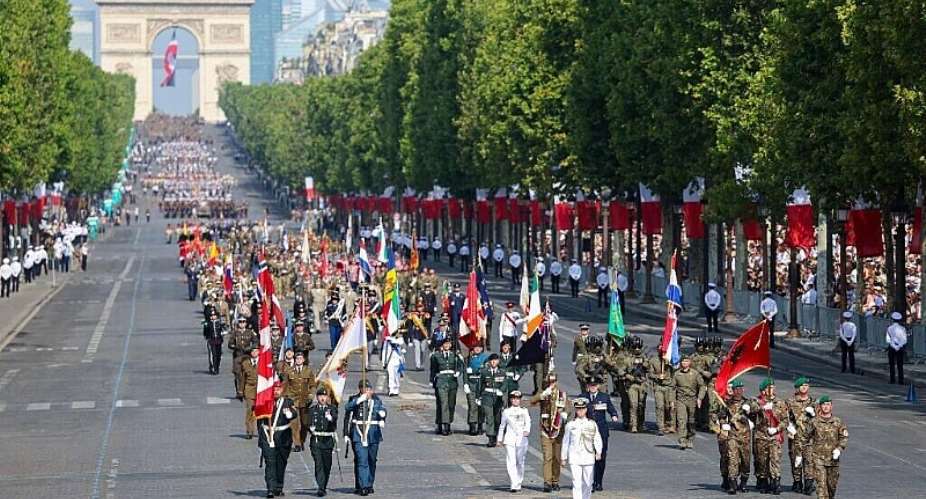 Coalition of volunteers of invited foreign nations march down the Champs-Elyses during the annual Bastille Day military parade, 14 July 2026. - AFP - LUDOVIC MARIN