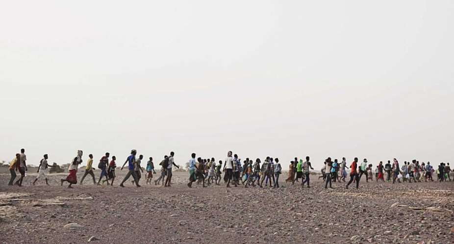 In this July 14, 2019 photo, smugglers lead Ethiopian migrants in Obock, Djibouti to embark on a route via Yemen to reach oil-rich Saudi Arabia to earn enough to escape poverty. - AP - Nariman El-Mofty