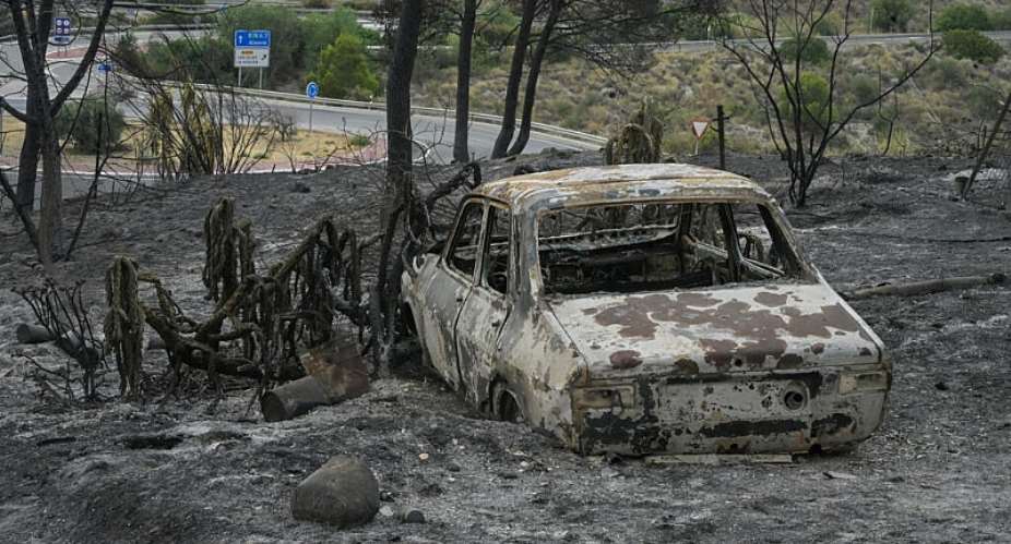 A wildfire that has killed at least 12 people in southern Spain was close to being brought under control, allowing hundreds of evacuated residents to return home. -  Jose Jordan, AFP