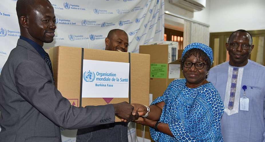 The Chief of Staff at the Ministry of Health, Mr Emmanuel SORGHO, receiving one of the emergency kits from WHO Representative in Burkina Faso, Dr. Alimata J. DIARRA-NAMA