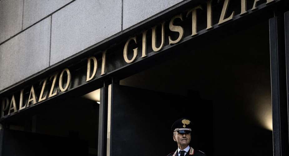 An Italian Carabinieri stands guard at the entrance of the courthouse the day of the verdict in the case of the Morandi Bridge collapse, Genoa, July 16, 2026. -  Marco Bertorello, AFP
