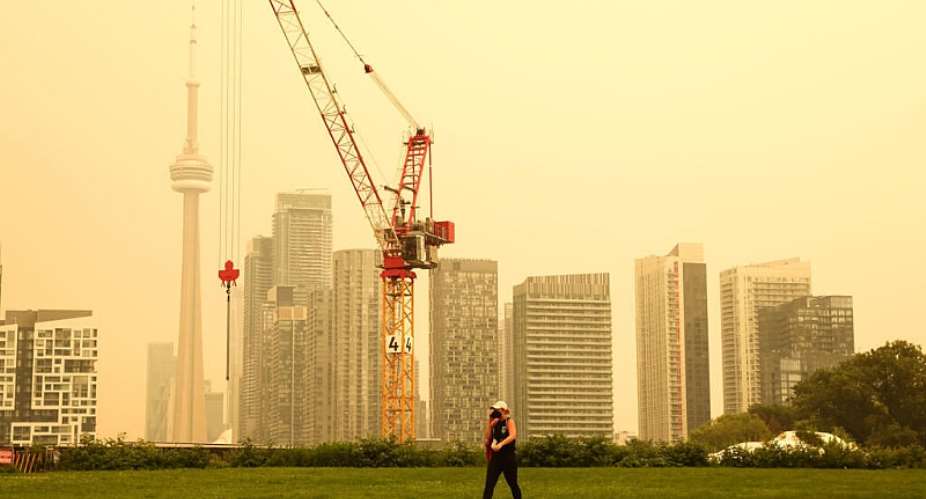 A person walks in downtown Toronto where the air quality is poor due to the forest firest in Northern Ontario. -  Cole Burston, AFP