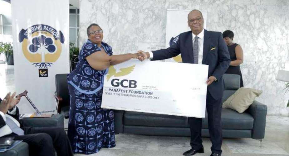 Anselm Ray Sowah presenting the cheque to Prof Esi Sutherland-Addy