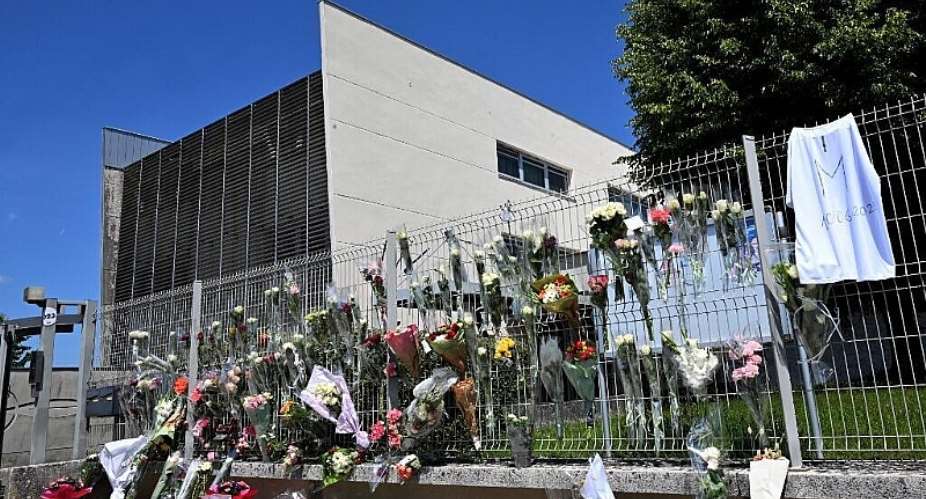Flowers were laid outside the Francoise Dolto middle school in Nogent on 11 June, 2025, a day after a 15-year-old fatally stabbed one of the schools assistants during a bag search. - AFP - FRANCOIS NASCIMBENI