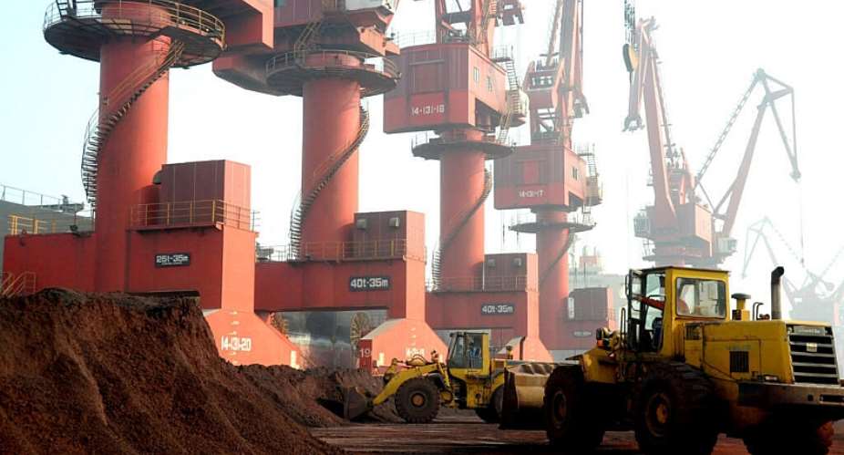 Workers transport soil containing rare earth elements for export at a port in Lianyungang - REUTERS - CHINA STRINGER NETWORK