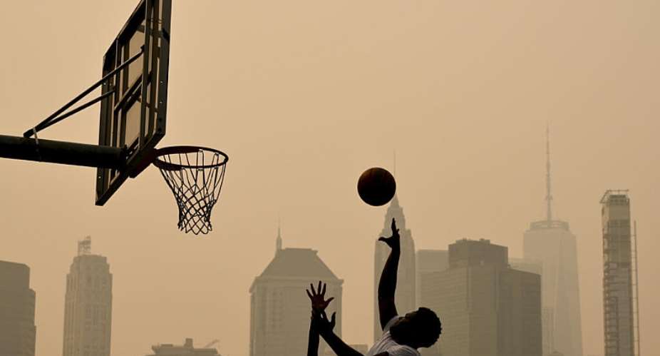 People play basketball as wildfire smoke from Canada causes hazy conditions in New York. -  Angela Weiss, AFP