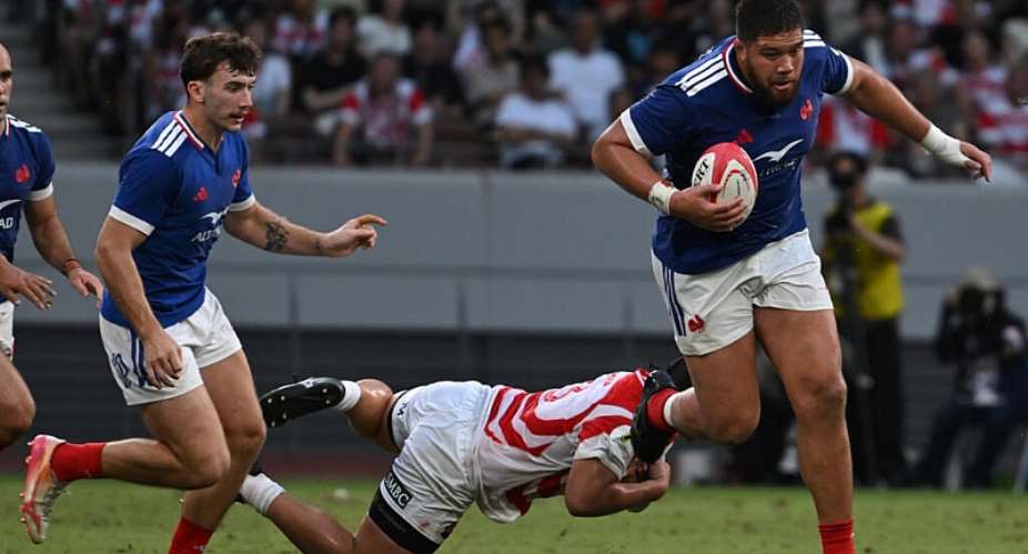 Frances Emmanuel Meafou runs with the ball against Japan. -  Andrew Caballero-Reynolds, AFP