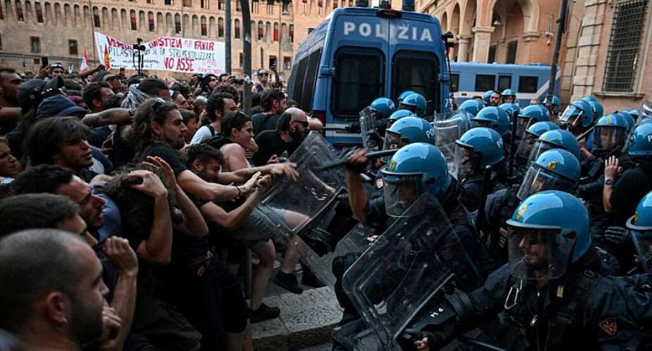 Protesters clash with riot police during a protest following the death of Abderrahim Fakir in Bologna, Italy, July 20, 2026. -  Michele Lapini, Reuters
