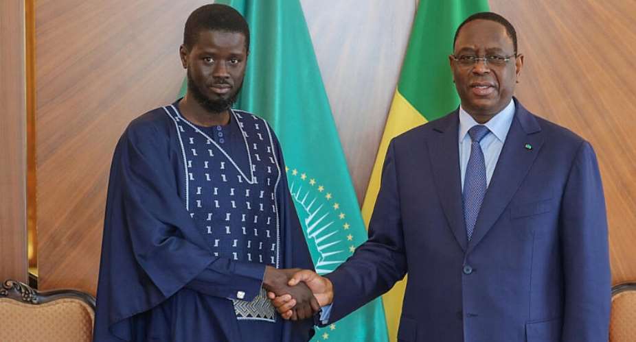 Outgoing Senegalese President Macky Sall shaking hands with with Senegals president-elect Bassirou Diomaye Faye at the Presidential palace in Dakar, on 28 March, 2024. - AFP - -
