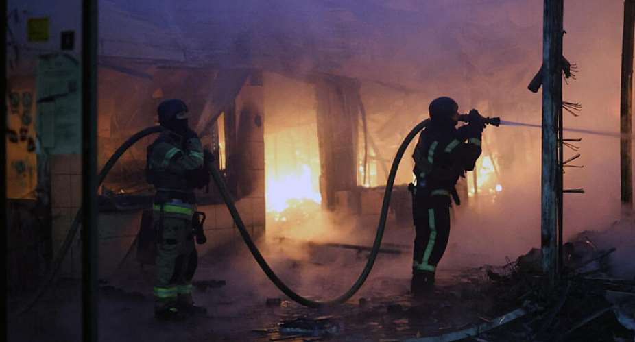 Firefighters put out a blaze at a market during the Russian missile strike on the Ukrainian capital of Kyiv -  Serhii Okunev, AFP