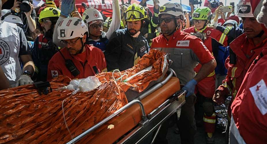 Rescue workers load Hernan Gil, a survivor of Venezuelas twin earthquakes, into an ambulance in Catia La Mar, La Guaira State, Venezuela on July 2, 2026. -  Federico Parra, AFP