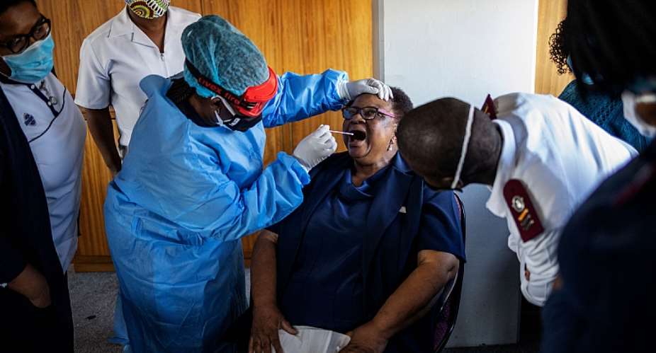 A nurse demonstrates how to perform a swab test in Johannesburg, South Africa. - Source: Michele Spatari  AFP via Getty Images