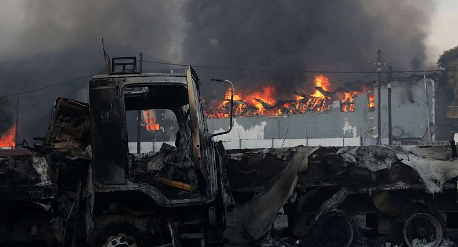 Trucks and business were looted and burnt during recent riots in South Africa.  - Source: EPA-EFEStringer