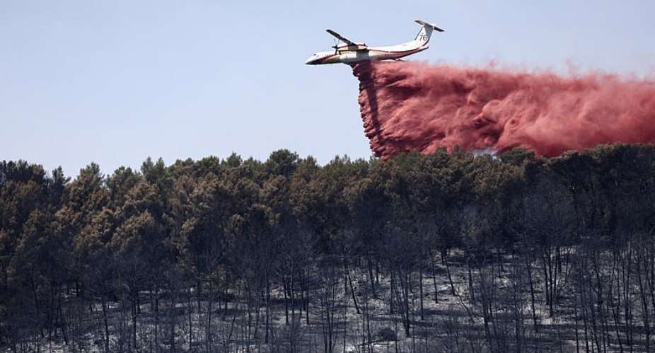 A Dash 8 - Q400MR aircraft drops fire retardant to slow the spread of a wildfire in Taradeau, France on July 20, 2026. -  Thibaud Moritz, AFP
