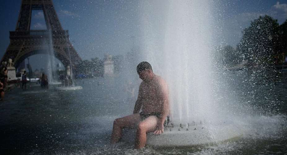 A man cools off at the Trocadero fountain near the Eiffel Tower during a heatwave in Paris, June 24, 2026. -  Christophe Ena, AP