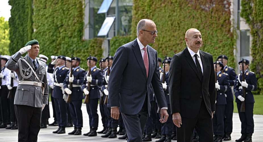 German Chancellor Friedrich Merz (L) and Azerbaijans President Ilham Aliev (R) react after inspecting the honor guard during a welcoming ceremony at the Chancellery in Berlin on July 21, 2026. - AFP - TOBIAS SCHWARZ