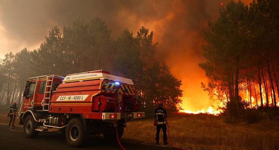 Firefighters try to extinguish fires burning trees using a wildland water truck near Le Porge, southwestern France, on July 23, 2026. -  Romain Perrocheau, AFP