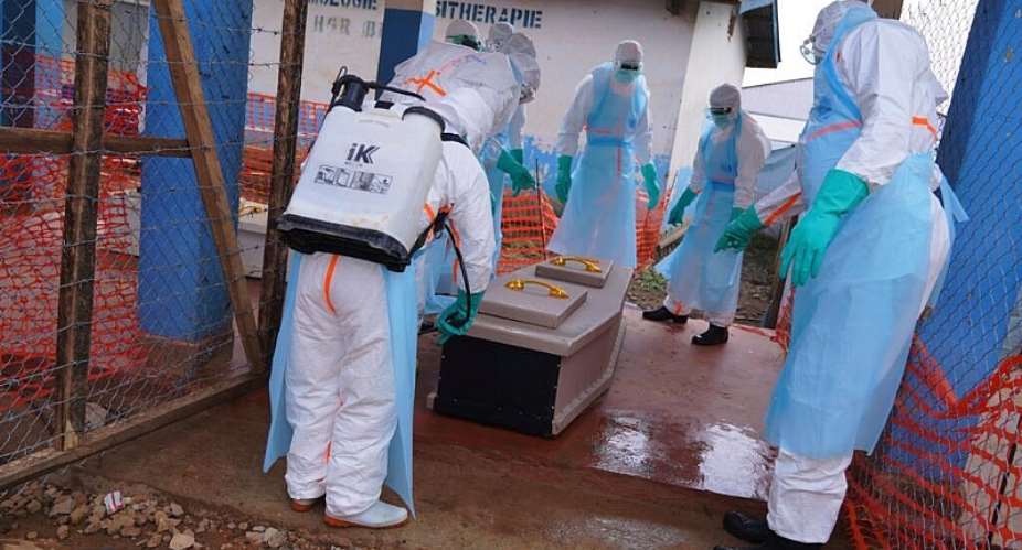 Health workers disinfect a coffin of an Ebola victim at Ebola Treatment Center at Bunia General Hospital in Ituri, DR Congo, on 22 July, 2026. - AP Photo/Dirole Lotsima Dieudonn - Dirole Lotsima Dieudonne
