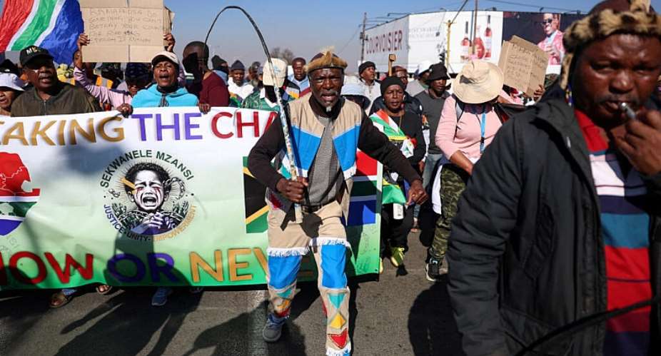 Anti-immigrant protesters march in Johannesburg, South Africa, on 9 July 2026. The country has seen a tide of demonstrations and violence against foreign residents. -  REUTERS - Oupa Nkosi