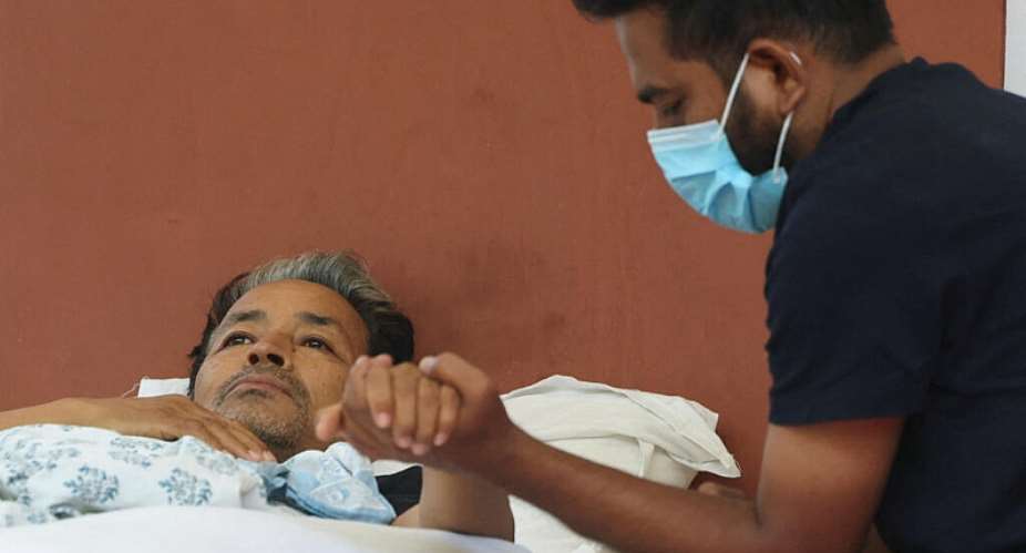 Abhijeet Dipke, head of the Cockroach Janta Party (CJP), holds the hand of Sonam Wangchuk, an Indian education reformer, who has been on hunger strike at Jantar Mantar in New Delhi, India, on July 18, 2026. -  Bhawika Chhabra, Reuters