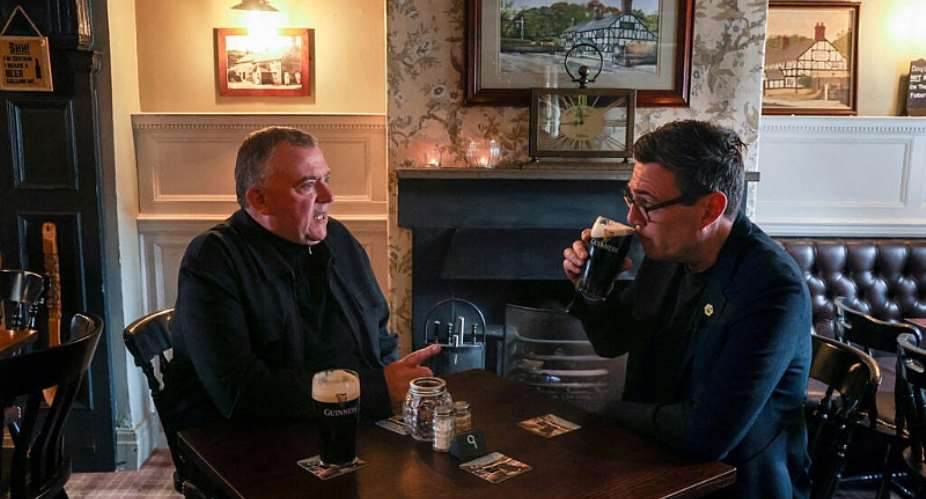 UK Prime Minister Andy Burnham chats to a pub landlord in Wigan ahead of a by-election for parliament on June 5, 2026. -  Temilade Adelaja, Reuters