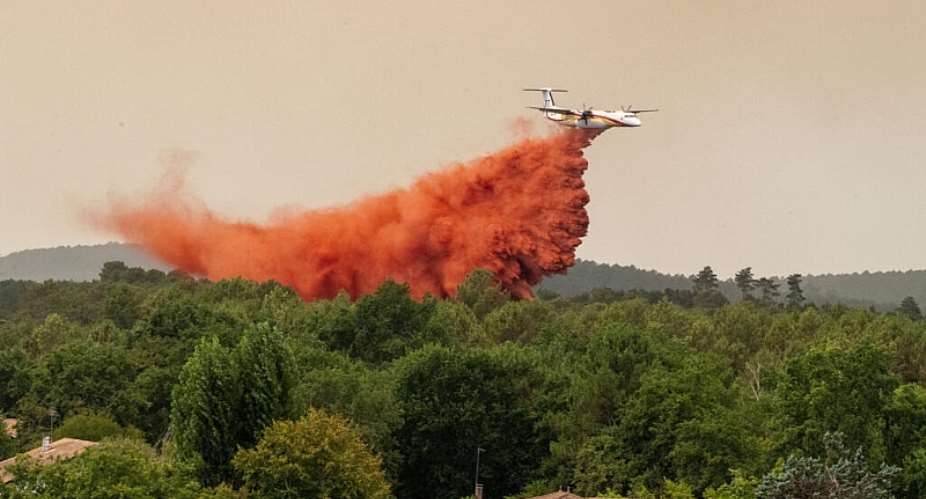 A water bomber drops water while fighting wildfires in western France on July 23, 2026. -  Caroline Blumberg, AP