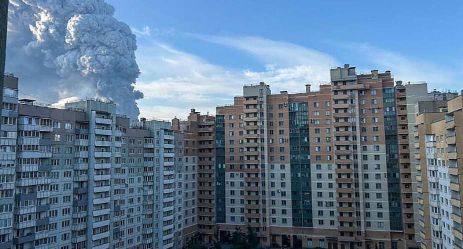 This picture taken on July 24, 2026 in Saint Petersburg shows smoke rising into the sky over residential buildings. Ukrainian drones hit a warehouse for a Russian e-commerce giant near Saint Petersburg early on July 24, triggering a fire that sent smoke pouring over the historic city. -  AFP