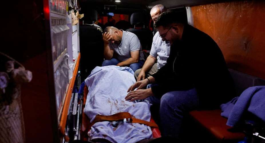 Palestinians sit next to the body of a Palestinian aboard an ambulance before their funeral, who was killed in a deadly shooting incident, according to Israeli and Palestinian health officials, near the village of Tal, in Nablus, in the Israeli-occupied West Bank, July 25, 2026. -  Mohammed Torokman, Reuters