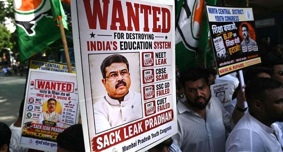 Indian Youth Congress party workers hold placards of Indias Education Minister Dharmendra Pradhan during a protest  over the alleged NEET exam irregularities in Mumbai on June 2, 2026. -  Indranil Mukherjee, AFP