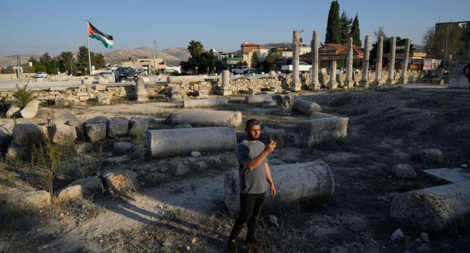 A Palestinian visitor takes a photo at the Roman historical site in the West Bank town of Sebastia on November 20, 2025. -  Nasser Nasser, AP