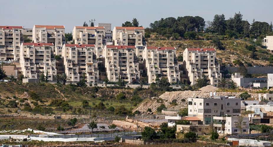The Kiryat Arba settlement in the background near Palestinian houses near Hebron, in the Israeli-occupied West Bank, 7 May 2026. -  Mussa Qawasma/Reuters