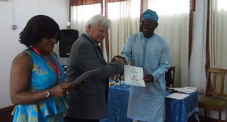 Dr Bitugu receiving his certificate from Kapustin