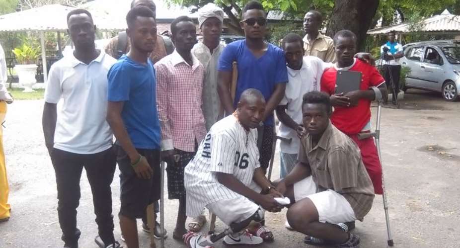 Ofosu Squatting L in a pose with some of his friends