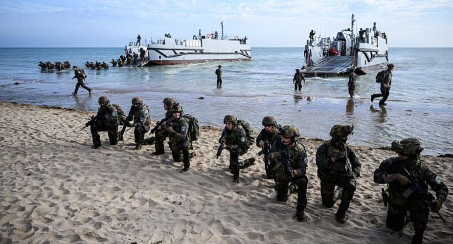 French troops disembark from a US landing craft during a joint US and French amphibious landing operation showcase, on June 4, 2024, at Omaha beach in Saint-Laurent-sur-Mer, northwestern France. -  Loic Venance, AFP