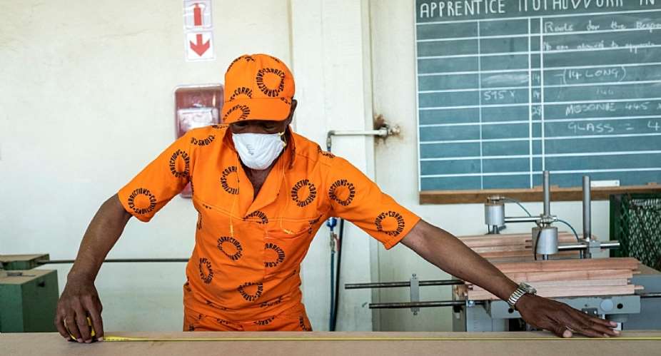 An inmate busy in the woodwork area of The Leeuwkop Correctional Facility. - Source: WIKUS DE WETAFP via Getty Images