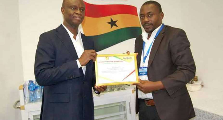 Yahaya Alhassan presenting the Award to Joe Anokye