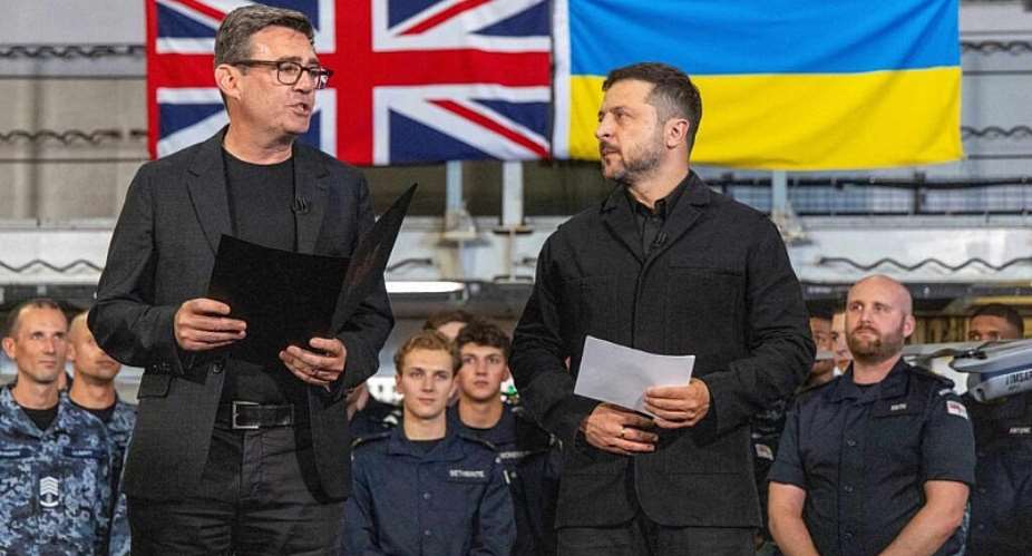 Britains Prime Minister Andy Burnham and Ukraines President Volodymyr Zelensky speak to troops on board the Royal Navy aircraft carrier HMS Queen Elizabeth during their visit to HM Naval Base in Portsmouth on the south coast of England on 27 July 2026. - AFP - SIMON JONES