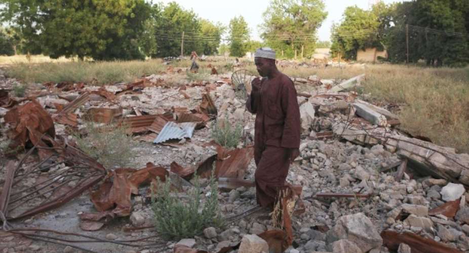 Maiduguri in northeastern Nigeria, a man stands in the ruins of a destroyed mosque.