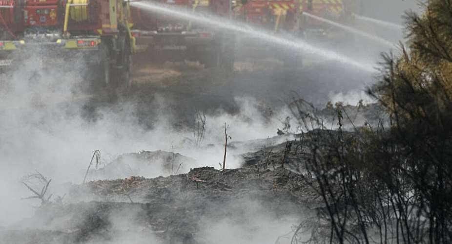 Firefighters carry out mop-up operations, extinguishing remaining hot spots and  smoldering patches, in a forest near Marcheprime, some 30 km from Bordeaux, on July 27, 2026. -  Alain Jocard, AFP