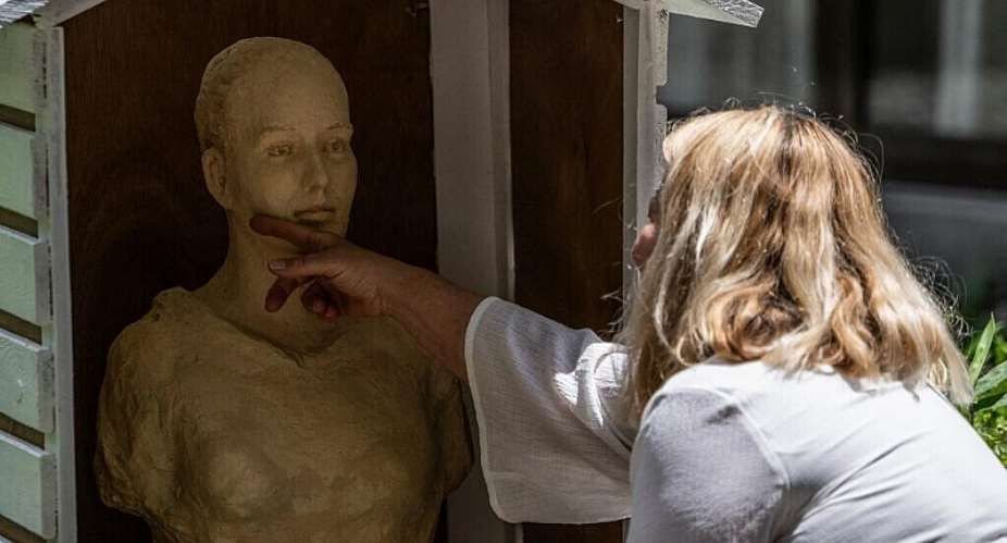 Anne Dsert, mother of Tiphaine Vron, who disappeared in Nikko in 2018, touches the statue made by Japanese sculptor Mana Yokoi in Tiphaines honour during a ceremony in Nikko on 29 July, 2026, marking a tribute to the missing French woman. - AFP - ANDREW CABALLERO-REYNOLDS