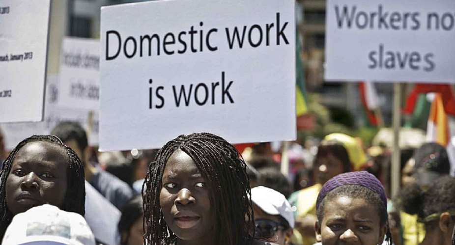 Migrant domestic workers march at Beirut's seaside and hold banners demanding basic labor rights as Lebanese workers during a 2013 protest. The recent beating of two Kenyan domestic workers in Lebanon highlights the ongoing problem of violence against Black women in Arab countries. Photo: Hussein MallaAP