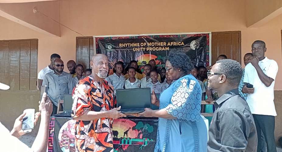 Baba George handing over the donated laptops to the headmistress of Bakpe D.A Basic School, Madam Wendy Ewoenam Kponyo and Osborn Martin Gatugbe, the Chief Director of Somnia Osbrain Foundation