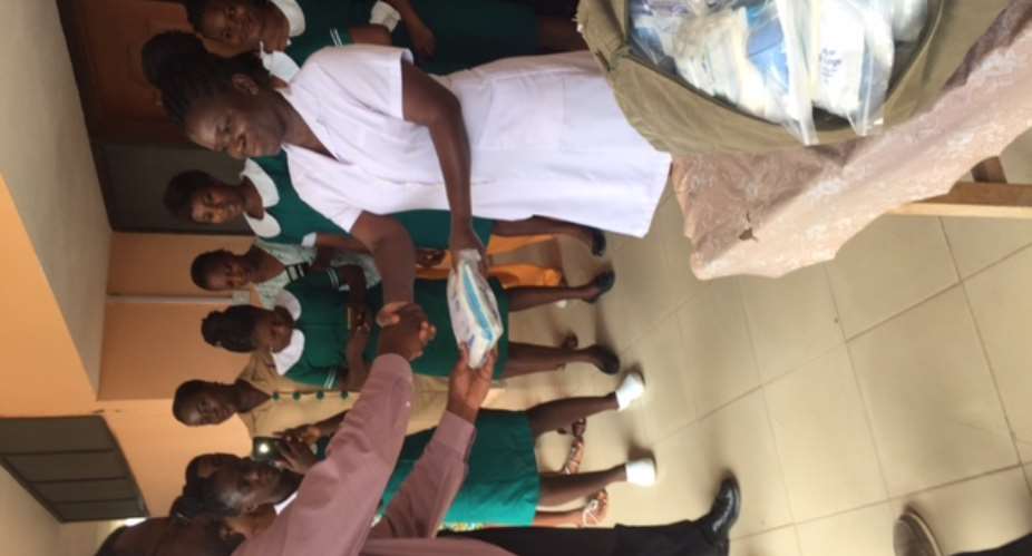 Madam Lizbeth Ansah Midwife receives maternity kits on behalf of the  Elmina Urban Health Centre  from Prof. Ulzen