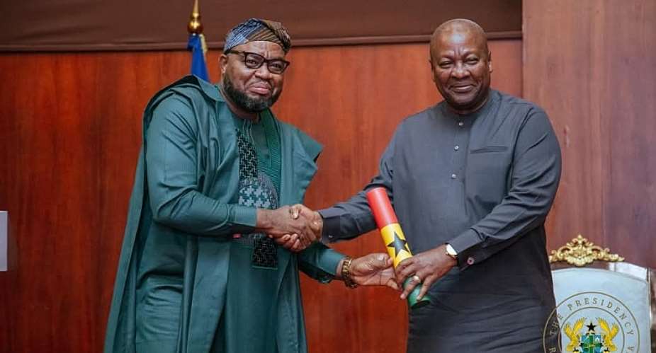 Hon. Sukparu receiving his Instrument of Appointment from H. E. John Dramani Mahama