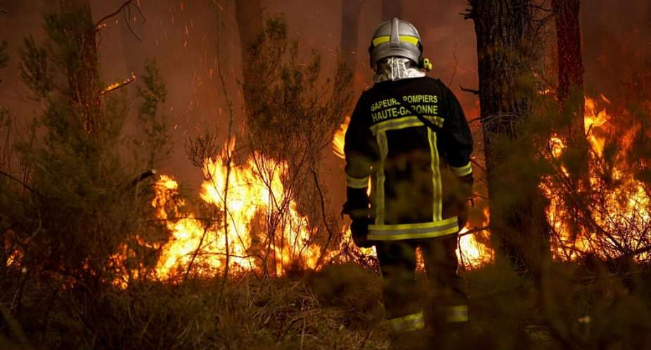 A firefighter stands before flames as a forest fire rages in Saint-Jean-dIllac, some 30km from Bordeaux, on July 26, 2026. -  Romain Perrocheau, AFP