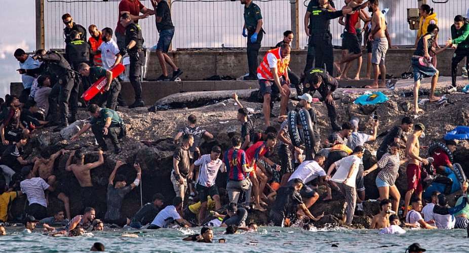 Migrants try to cross from Morocco into the Spanish enclave of Ceuta on Thursday, 30 July. - AP Photo/Antonio Sempere - Antonio Sempere